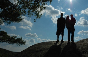 A family posing on a hill.