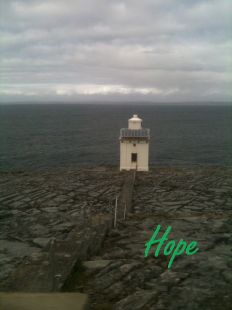 A lighthouse with text saying hope.